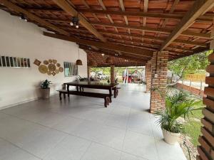 a patio with a ping pong table and a wooden ceiling at Amaro Residence in Santo Amaro