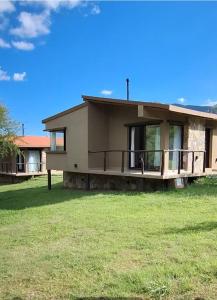 a house with a green lawn in front of it at Barcena Houses in Tumbaya