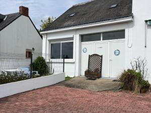 a white house with large windows and a driveway at Gîte Authentique en Plein Cœur du Parc de la Brière, Proche Marais, Terrasse Sud, Tout Équipé - FR-1-306-1001 in Saint-Malo-de-Guersac