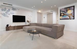 a living room with a couch and a table at Cozy Apartment In Malinska With Wifi in Malinska
