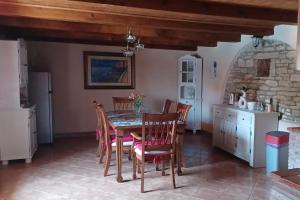 a kitchen and dining room with a table and chairs at Family friendly house with a swimming pool Barban, Central Istria - Sredisnja Istra - 24471 in Barban