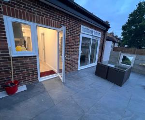 a patio with a sliding glass door and a fireplace at Princes 6HA in London +7 photos