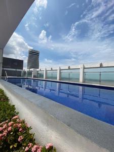 a swimming pool on the roof of a building at River view6 in Guayaquil