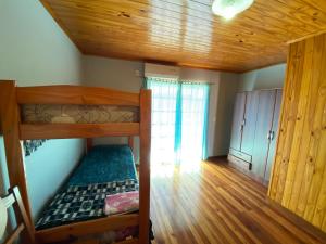 ein Zimmer mit zwei Etagenbetten und einer Holzdecke in der Unterkunft Joly in Wanda