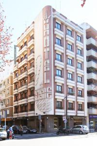 a large building with a sign on the side of it at El Cisne in Córdoba