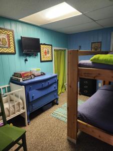 a room with two bunk beds and a tv at Lake Front Cottage on Private All-Sports Lake. in Le Roy +52 photos
