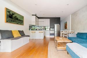 a living room with a couch and a table at Charming 3BR in Top Spot in Sydney