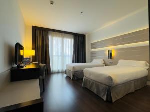 Postel nebo postele na pokoji v ubytování Hotel Palacio Albacete & SPA