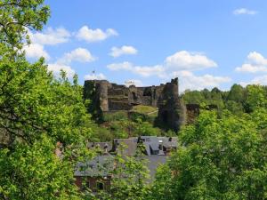 a castle on top of a hill with trees at Charming Apartment in Ardennes in Signy-lʼAbbaye