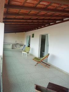 a room with two chairs and a table in a building at Suites de frente pra praia in Itapemirim