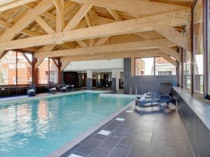 a large swimming pool with a wooden ceiling at Snowy Escape in Scenic Vallorcine in Vallorcine