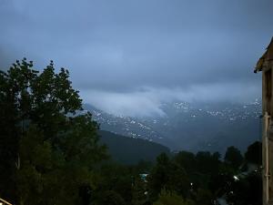 a view of a mountain with trees and a city at Bhurban Suites in Bhurban +13 photos