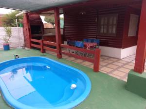 a large blue tub on a patio with a house at Cabañas del Valle JONIVA in Termas de Río Hondo