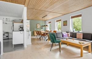 a living room with a couch and a table at 4 Bedroom Amazing Home In Østermarie in Østermarie