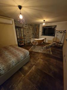 a room with a bed and a bath tub in it at Casa Onorio in Sorico