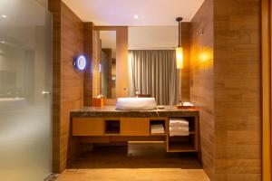 a bathroom with a sink and a tub at Hyatt Regency Kuantan Resort in Kuantan +47 photos