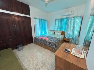 a small bedroom with a bed and a desk at RITU CAPITOL Homestay in Trivandrum +6 photos