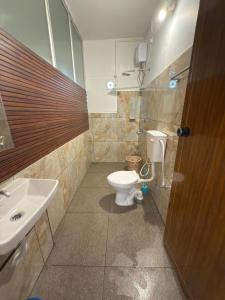 a bathroom with a toilet and a sink at RITU CAPITOL Homestay in Trivandrum