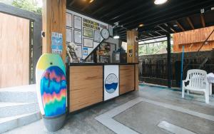 a store with a surfboard on the side of a building at RedDoorz @ Dolce Cabanas Beach Resort in Zambales