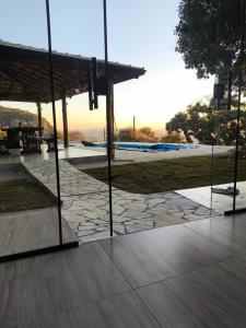 a view of a park with a pavilion and a stone patio at Chalé Bela Vista in Munhoz