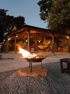 a fire pit in front of a building at Chalé Bela Vista in Munhoz