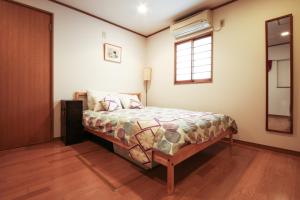 Postel nebo postele na pokoji v ubytování Fuji House West Shinjuku