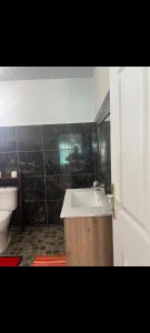 a bathroom with a sink and a toilet at Fare Kahaia Rangiroa in Avatoru +7 photos