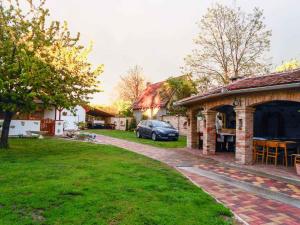 a car parked in a yard next to a house at Apartment Balatonbereny 2 in Balatonberény
