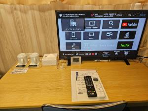 Uma televisão e/ou sistema de entretenimento em Select Inn Shimada Ekimae
