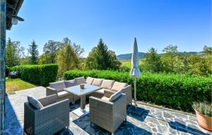a patio with a table and chairs and an umbrella at 3 Bedroom Cozy Home In Karlovac in Karlovac +58 photos