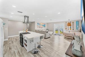 a kitchen and living room with a couch and a table at 332 Formosa Drive in Cocoa Beach +24 photos