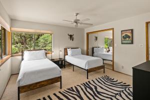 a bedroom with two beds and a window at Mountain Shadows Escape with a Yoga Studio! in Sedona