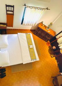 a bedroom with a bed with an open book on it at Ananda Home in Tân Hiệp