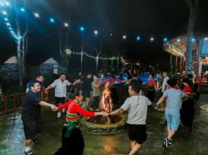 a group of people dancing around a fire at a party at Puluong Ly Van Garden in Làng Chiêu +81 photos