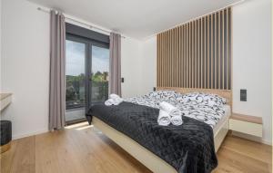 a bedroom with a bed and a large window at Lovely Home In Labin With Wifi in Labin