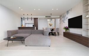 a living room with a couch and a tv at Lovely Apartment In Malinska in Malinska