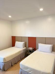 Postel nebo postele na pokoji v ubytování ILOILO GRAND HOTEL