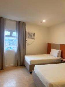 Postel nebo postele na pokoji v ubytování ILOILO GRAND HOTEL