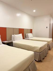 Postel nebo postele na pokoji v ubytování ILOILO GRAND HOTEL