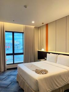 Postel nebo postele na pokoji v ubytování ILOILO GRAND HOTEL