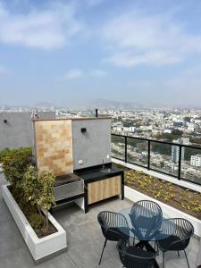 a patio with two chairs and a table on a roof at Apartment in San Isidro in Lima