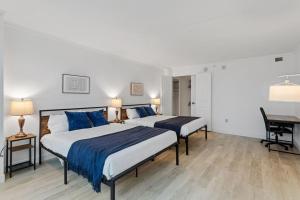 two beds in a white room with a desk and a table at Spacious 2BR CozySuites Condo at Showboat #24 in Atlantic City +38 photos