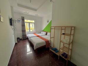 a bedroom with a bed and a book shelf at Hưng Phát Hotel in Da Lat