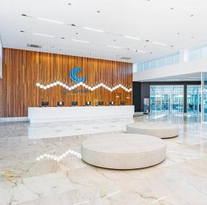 a lobby with two circular tables in a building at Salinas GAV Resorts in Salinópolis +30 photos