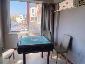 une pièce avec une table et deux chaises et une fenêtre dans l'établissement Thank Inn Hotel Jiangsu Huaian Lianshui Baiyue Square, à Paifang