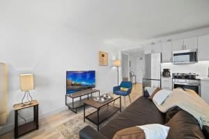 a living room with a couch and a kitchen at CozySuites Modern Studio Condo at Showboat #26 in Atlantic City