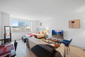 a living room with a couch and a table at CozySuites Modern Studio Condo at Showboat #26 in Atlantic City