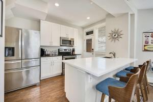 a kitchen with white cabinets and a white counter top at Massive Mid-Century Marvel 5 Bedrooms and Parking in Washington