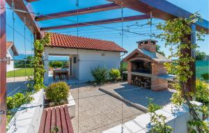 a house with a courtyard with a brick fireplace at Awesome Home In Benkovac With Jacuzzi in Benkovac +27 photos