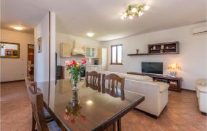 a living room with a table and a couch at Awesome Home In Benkovac With Jacuzzi in Benkovac